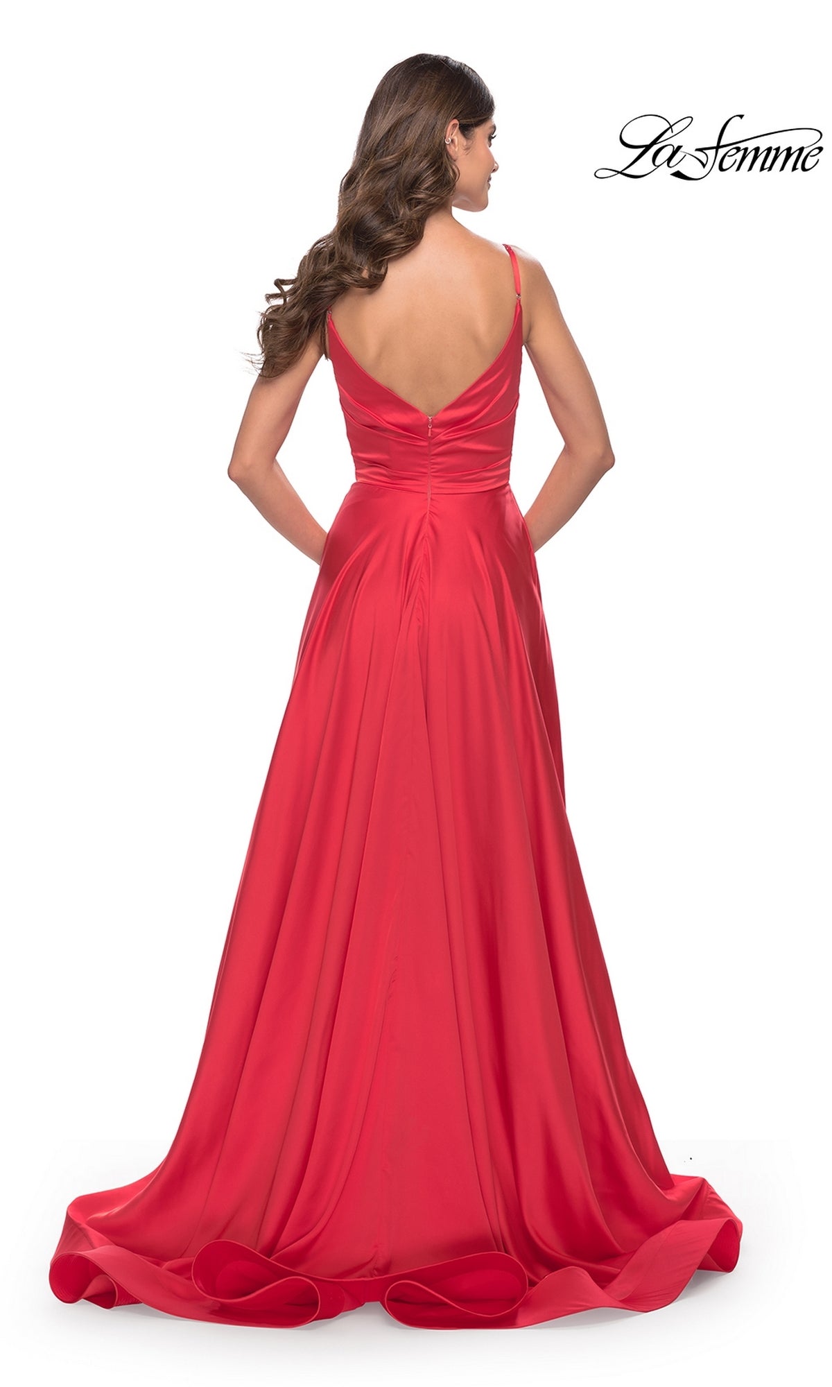 Woman in the La Femme Bright Long A-Line Prom Dress 31121, featuring a floor-length A-line silhouette and sleeveless design, posing against a white background.